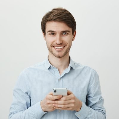 Portrait of perplexed thoughtful european guy standing with crossed hands, biting lip while looking up as if recalling something or thinking, over gray background. Should I call her today or not.